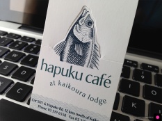 Novel pop-up Hapuku Cafe and Lodge logo business card, a business card and a calling card rolled into one. Digital illustration, logo design and graphic design, Christchurch, New Zealand.