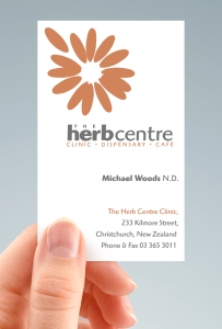 hand-held portrait of Herb Centre Clinic / Dispensary / Café business card, two-sided design, two colour, orange and grey, type and symbol logo, Healthcare, Brand and identity systems design, Illustration