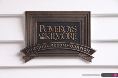 Pomeroy’s Boutique Accommodation cast bronze multi-level name plate located by the front door.