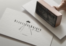 Closeup of rubber stamp of Beautiful Brides of Hope bridal couture logo. The symbol is set within and amongst type, showcasing the elegant, finessed bridal illustration and type that together create an integrated singular brand expression.