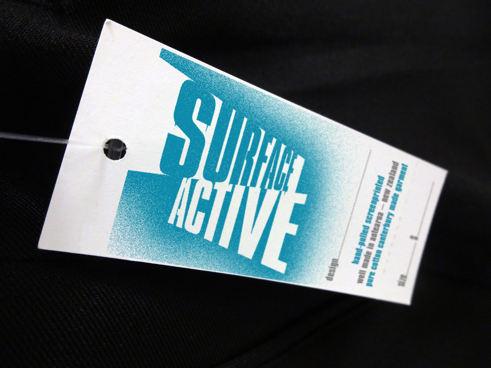 Surface Active T-shirt swingtag front.