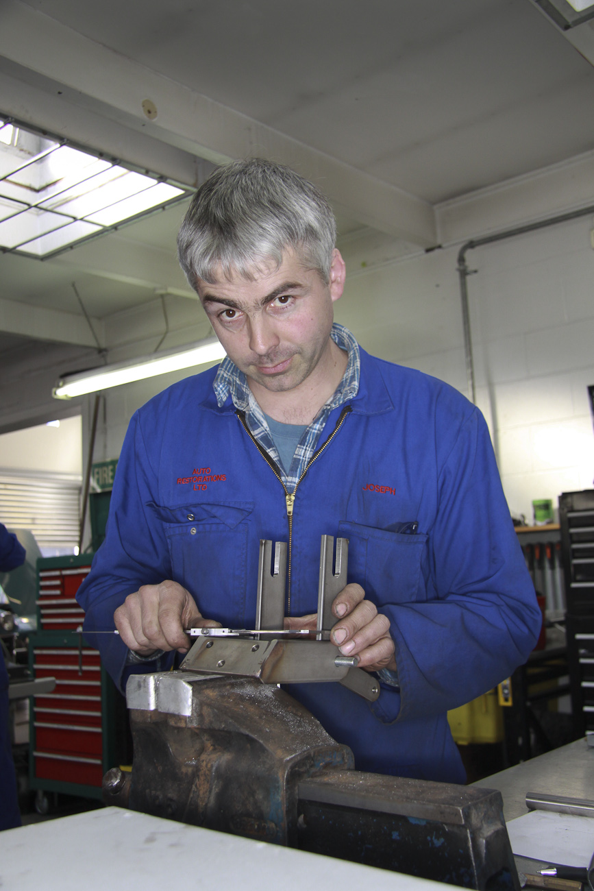 Joseph McClintock at work on a bespoke re-created chassis part in the Mechanical Shop at Auto Restorations.