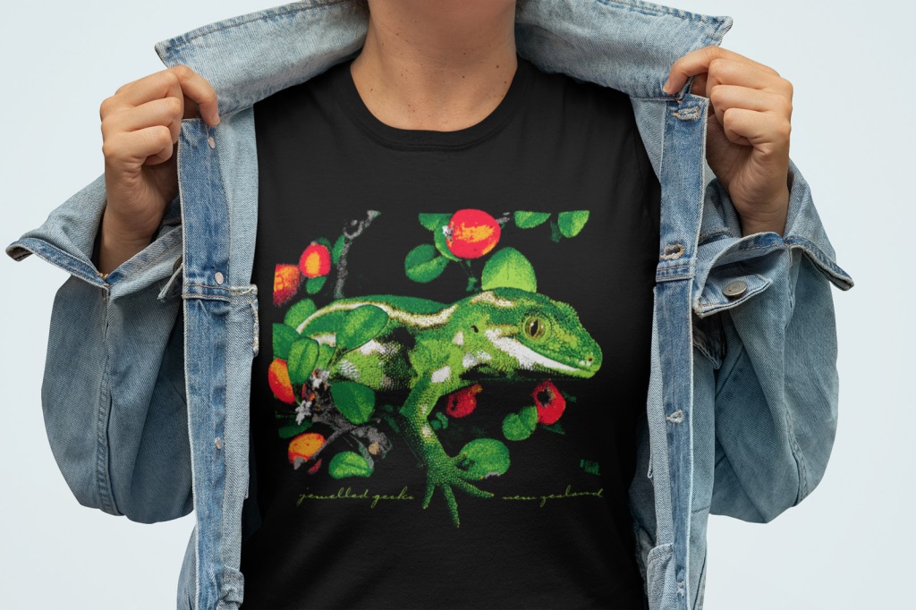 A woman showing off her black jewelled gecko New Zealand t shirt.