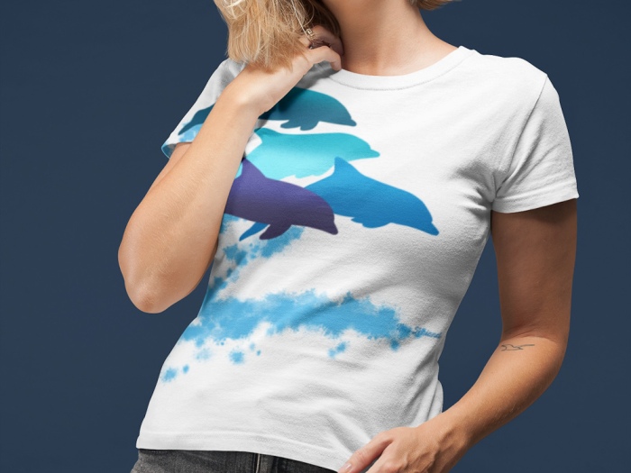 A woman wearing a dolphins leaping New Zealand all-over printed t-shirt with her hair all over her face.