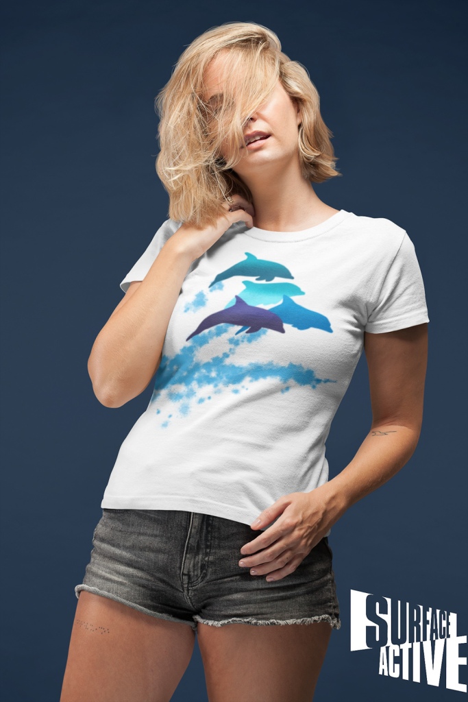 A woman wearing a dolphins leaping New Zealand t-shirt with her hair all over her face.